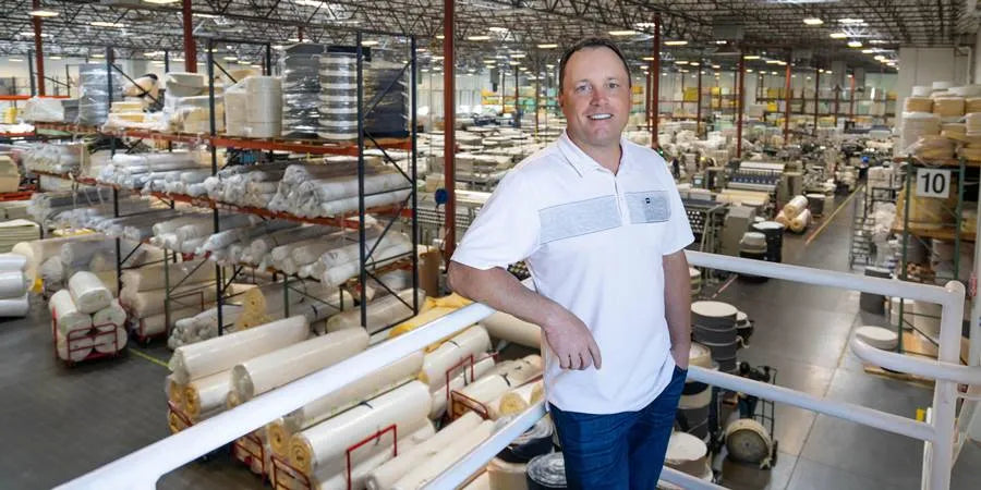 John Merwin, CEO of 3Z Brands, inspecting the mattress manufacturing process at the Phoenix factory.