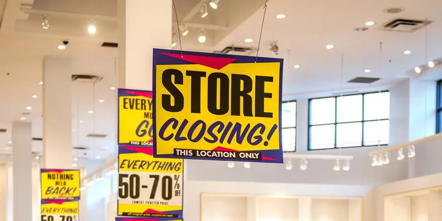 Store closing banner hanging from the ceiling.