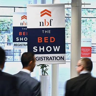 Inside the trade show with banner to register for The Bed Show.